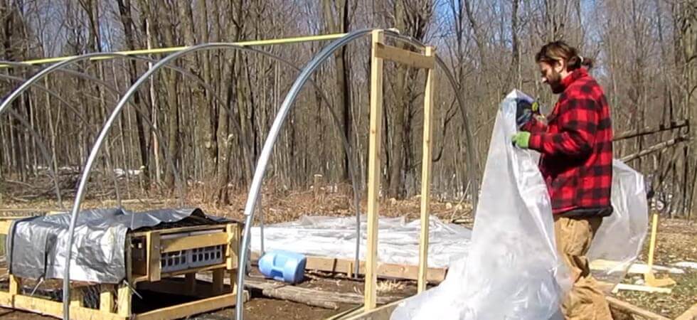 installing the hoop house plastic. DIY hoop house tutorial