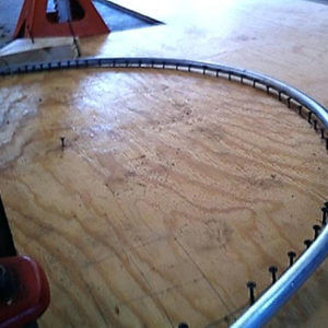 bending the poles to make the DIY hoop house