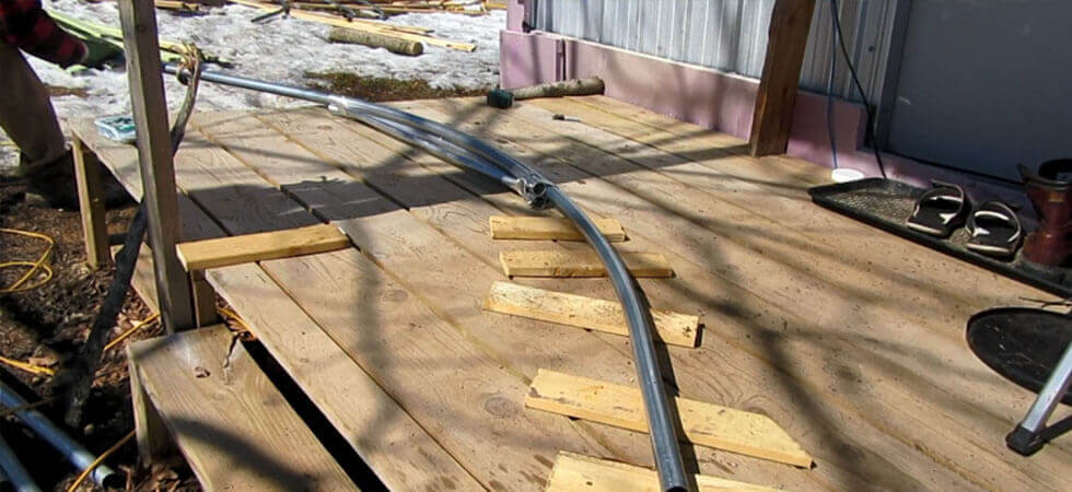 bending the poles for making the hoop house frames 